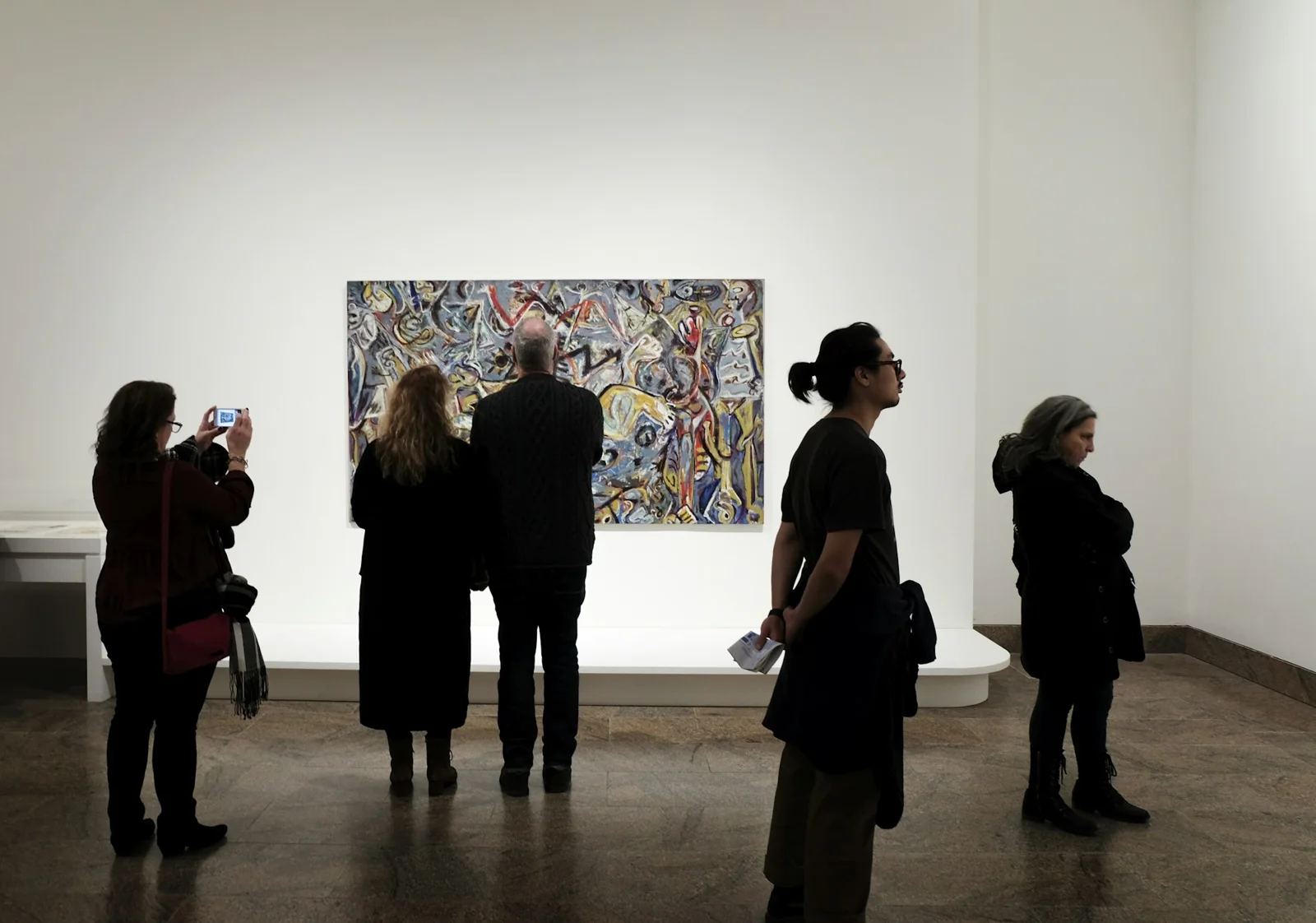 Visitors looking at a large artwork in a gallery (placeholder photo)